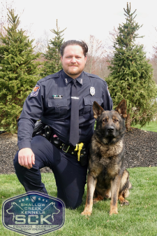 A police officer and a police dog. 