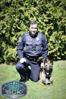 A police officer and a police dog. 
