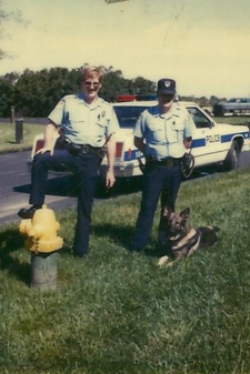 Two police officers and a dog. 